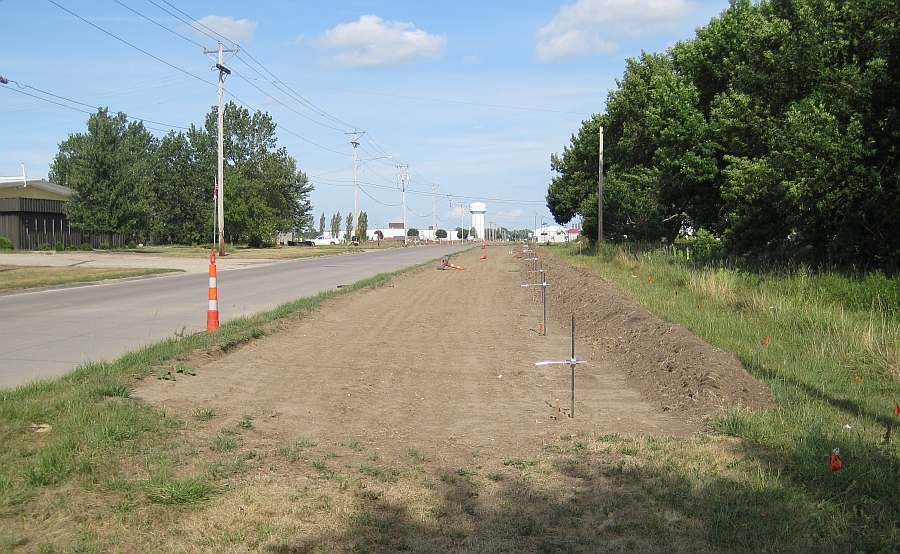 The dirt has been prepared for concrete.  Here the Loop Trail emerges onto Grimes Ave and heads east.