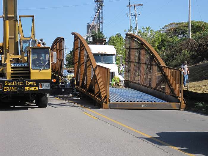 The other end of the bridge will be lifted off the second truck.