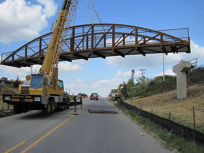 Workers pull the bridge around into place.