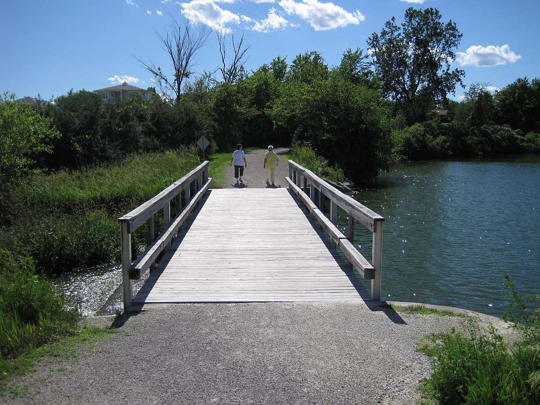 The Loop Trail crosses the Pleasant Lake spillway bridge, heading west.