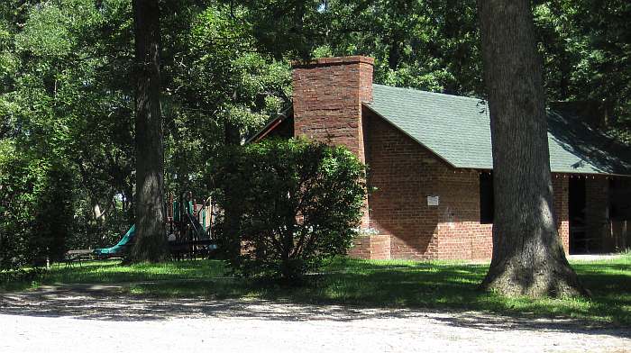 he brick shelter house, with a playground behind it.