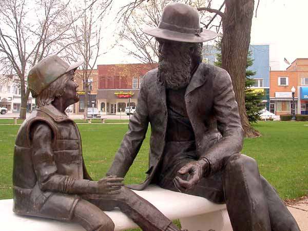 William Henry Coop was the first pioneer settler born in Jefferson County (1836). He and his young friend have been sitting in Central Park since 1981 (sculpted by Christopher Bennett).