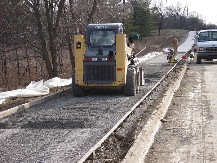 Stone is brought into the form, then tamped down.