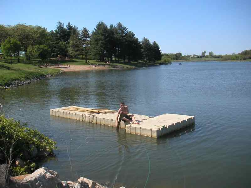 Rowing the new dock into place in Reservoir #1 at Waterworks Park