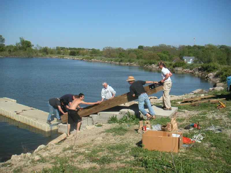 Moving the dock pier into place in Reservoir #1 at Waterworks Park