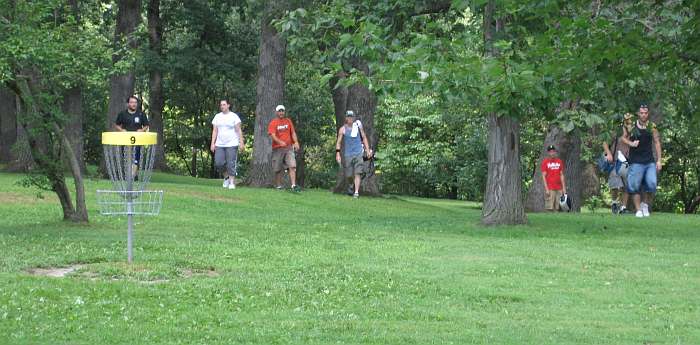 Approaching hole # 9 after throwing their disks from afar.