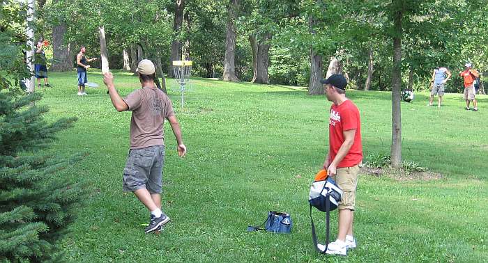 This player is throwing the disk from the spot where his landed.