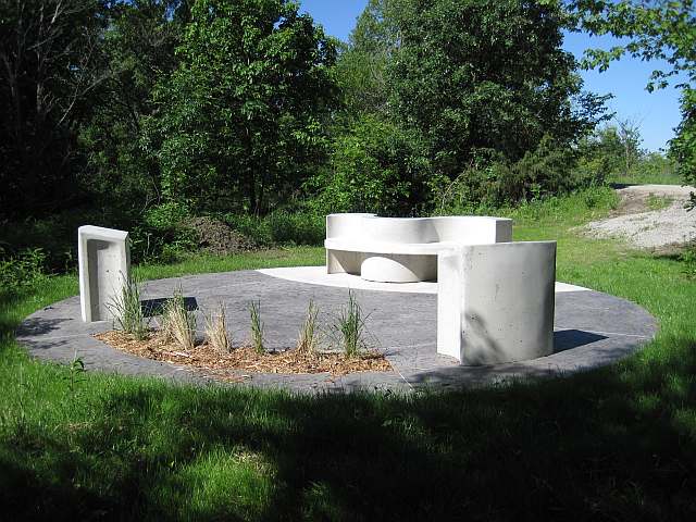 The grass has grown since the bench and pillars were set up.