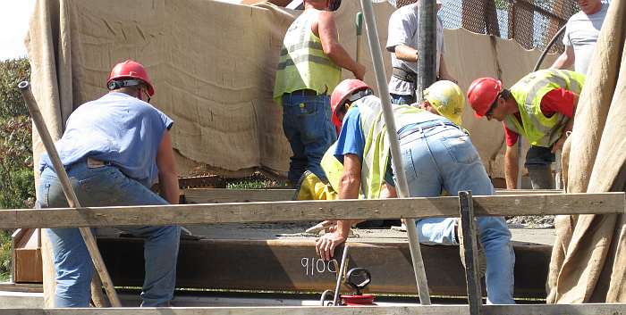Finishing work is done as they go along. The curbs are molded in.