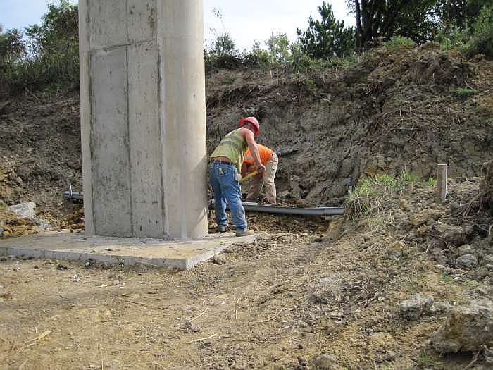 A water line, a natural gas line, and telephone lines are also buried nearby.