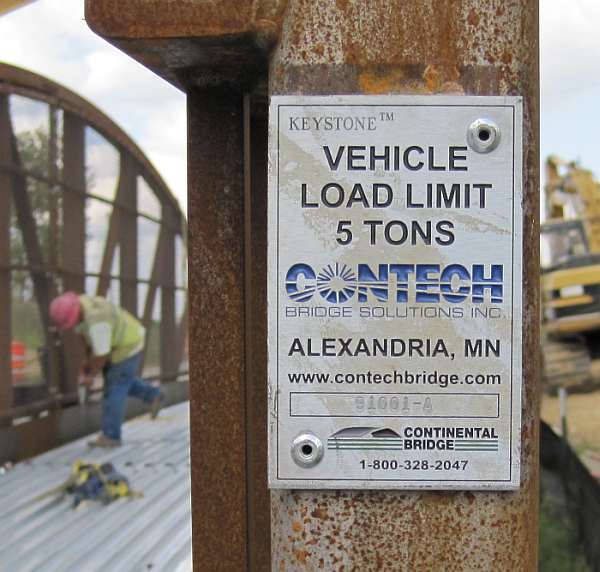 The builder's plate. The bridge finish is a natural rust, which protects the steel.