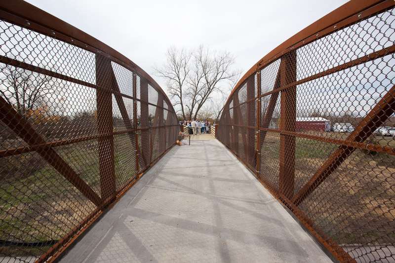 The bridge finish is a natural rust, which protects the steel.  No maintenance is needed.
