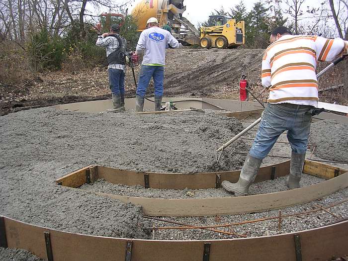 10/27/09.   The front-end loader goes back to the concrete truck for more.