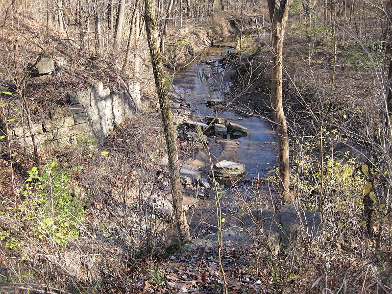 Many of the abutment stones have fallen into the creek.